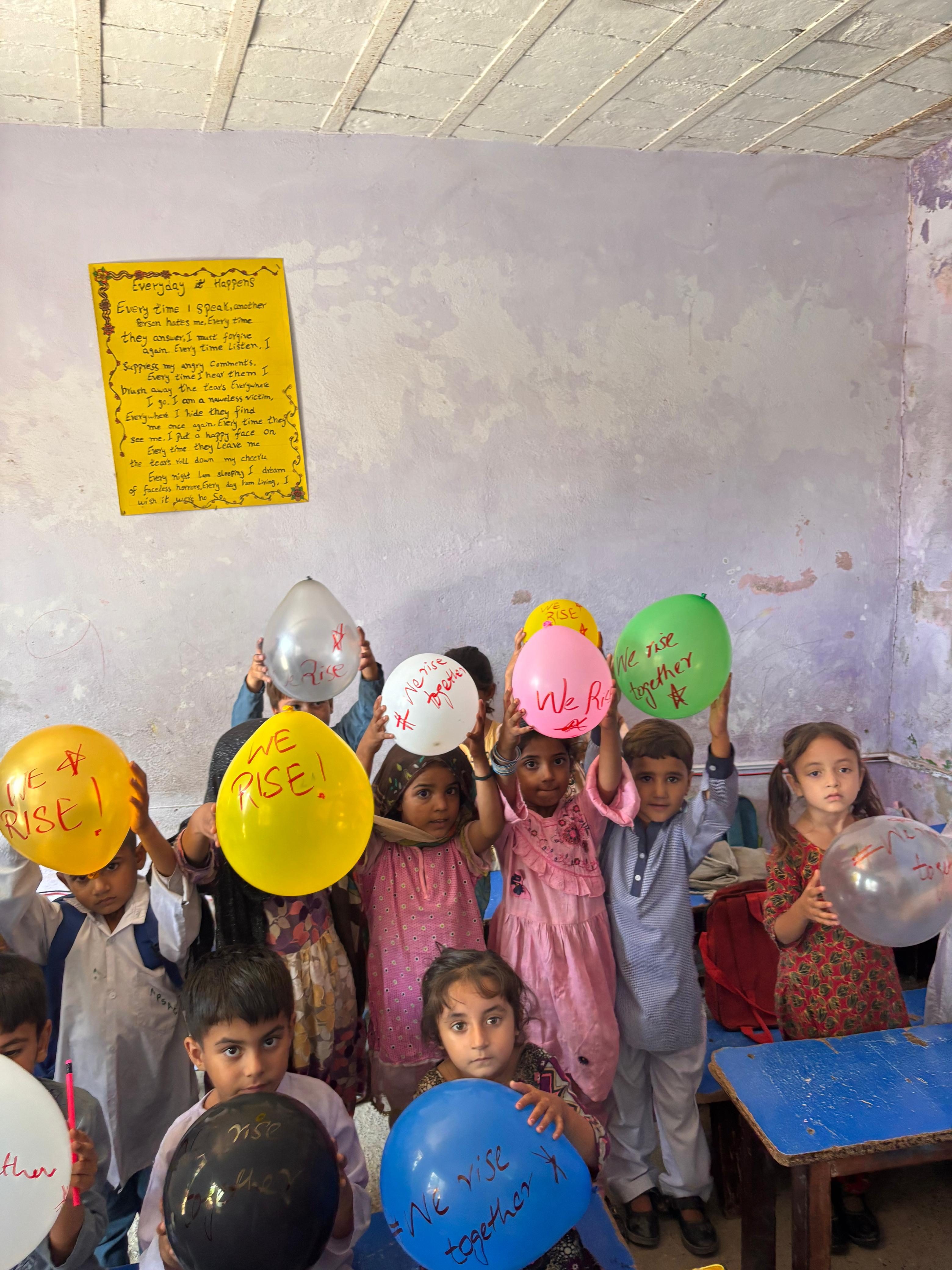 Children with balloons representing hope and education